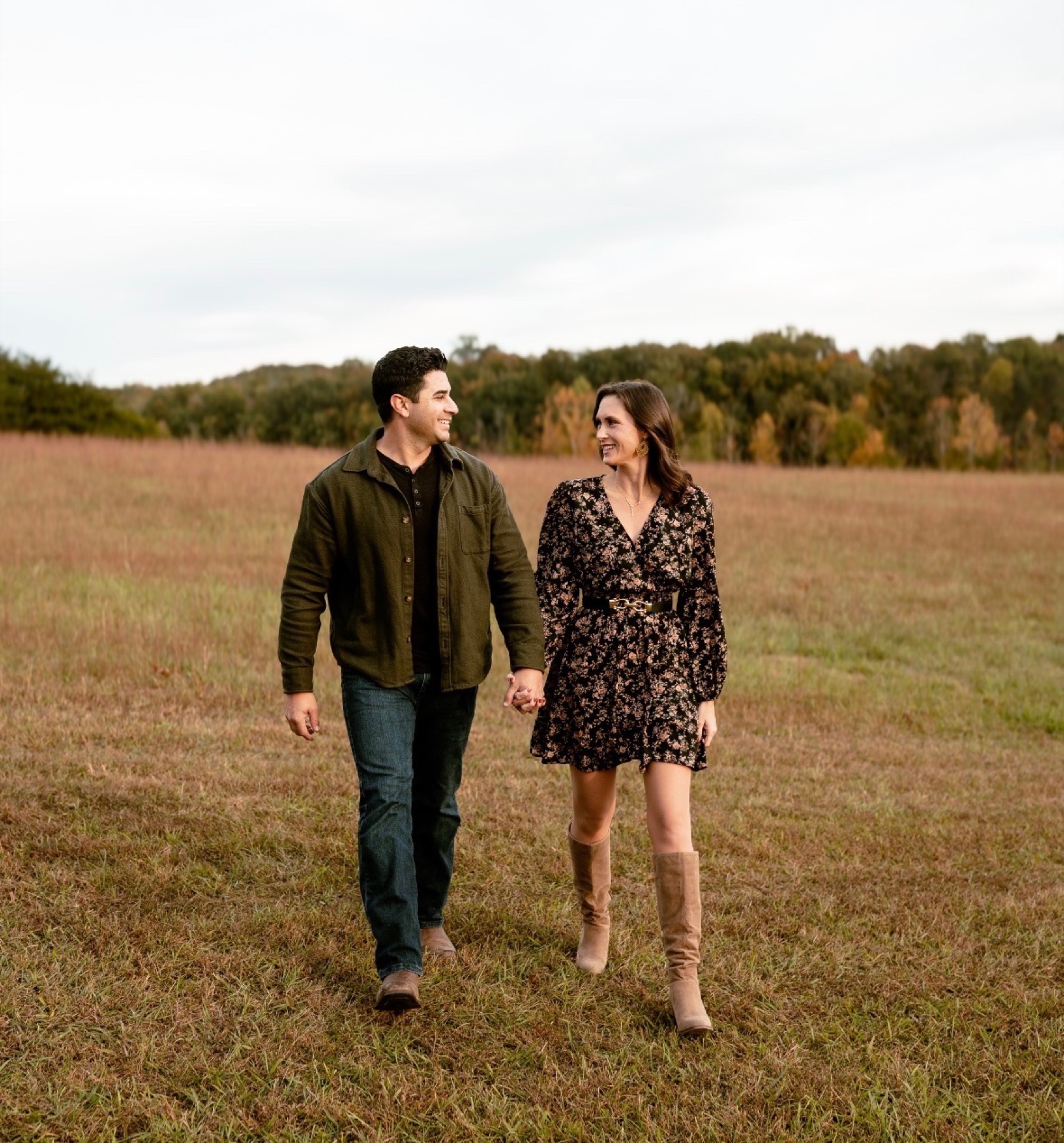 A couple walking through a warm East Tennessee field in fall