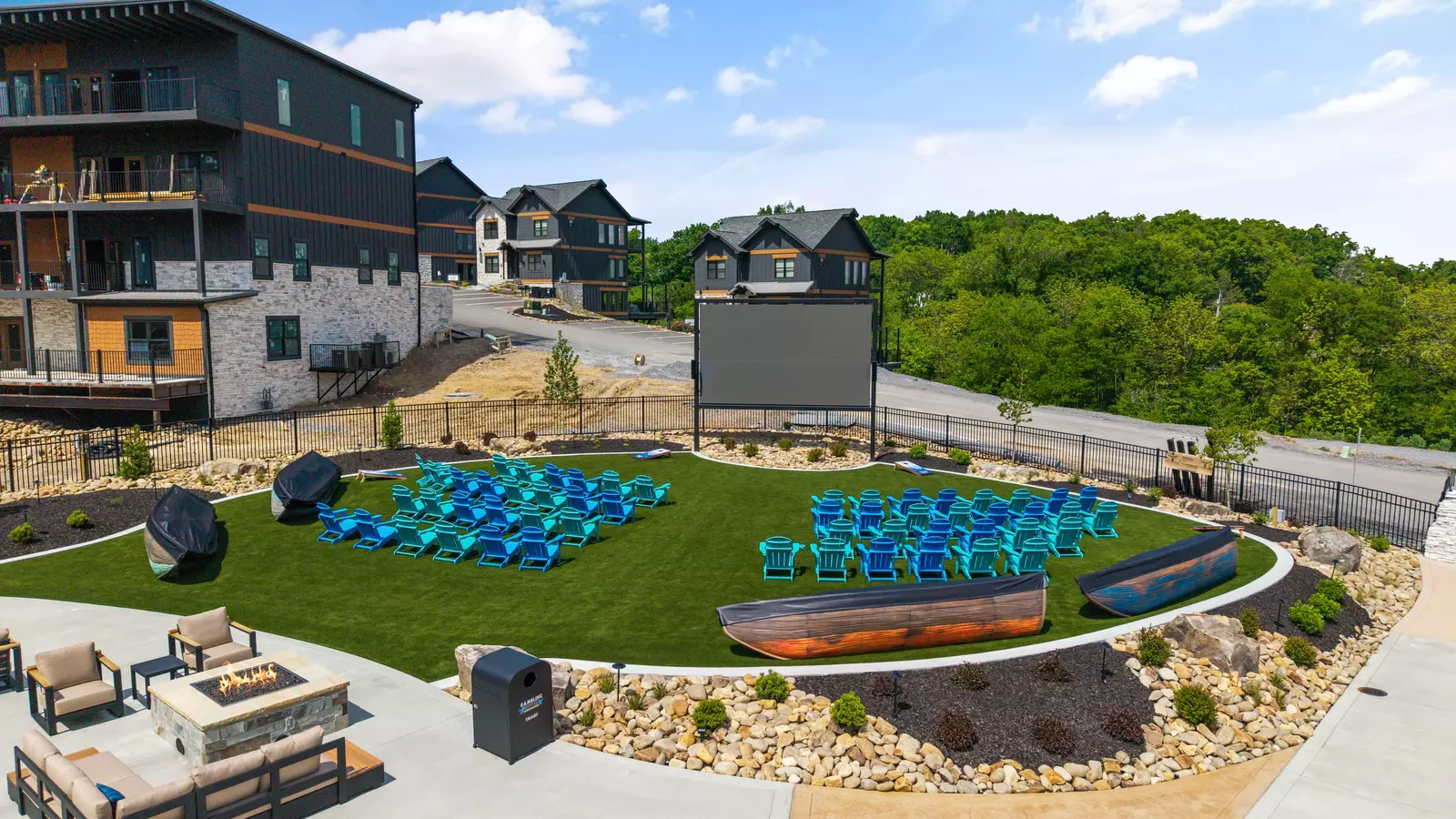 Outdoor movie lawn with colorful chairs beside Rambling River Waterpark