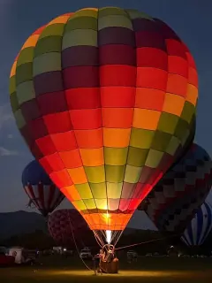 A colorful hot-air balloon glowing at an East Tennessee gathering