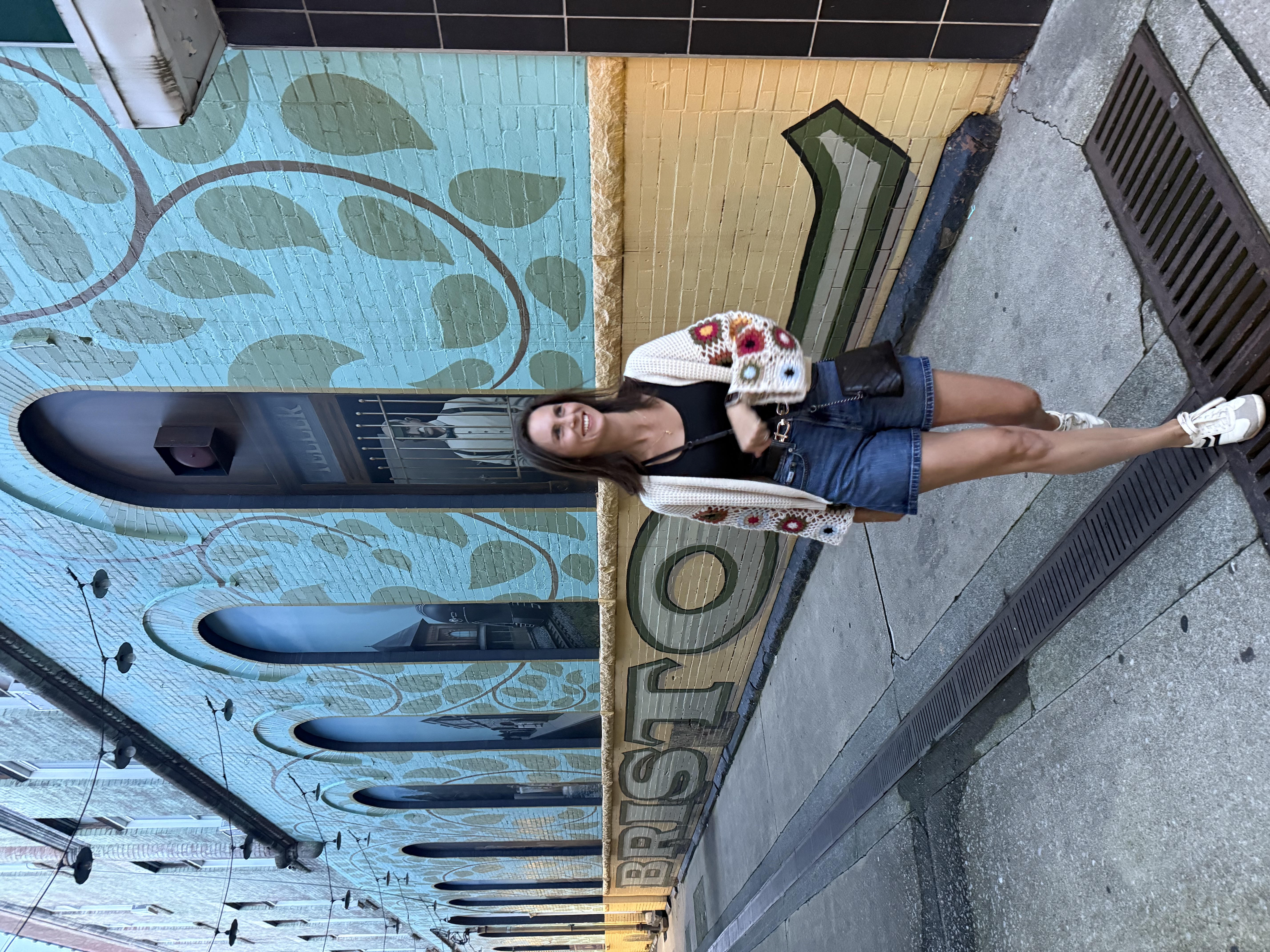 Walking in an alley with blue and yellow mural in Bristol TN
