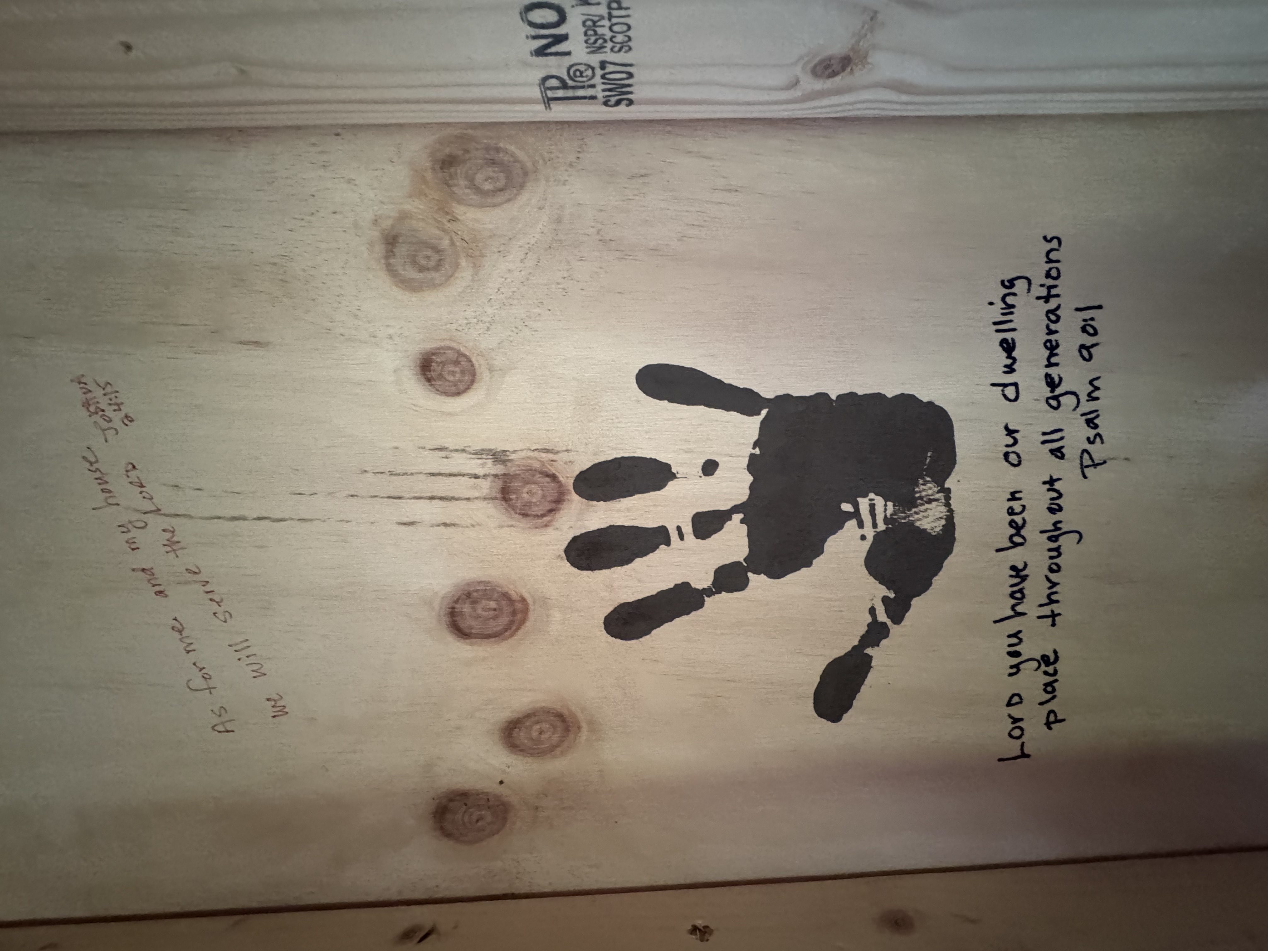 Handprint and Bible verse on cabin wall